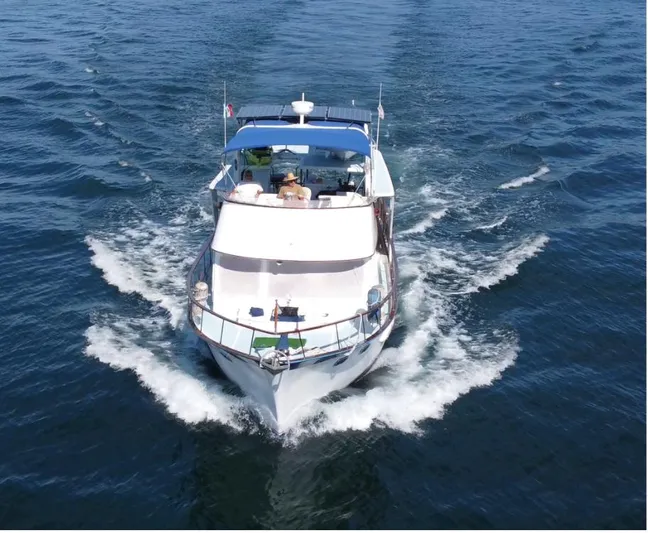 Ballena Blanca Yacht Photos Pics 1985 DeFever 44 Trawler cruising on open water, aerial view.