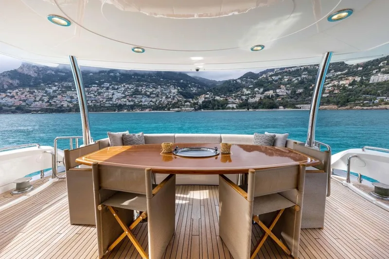 Sunseeker 90 Yacht Yacht Photos Pics Luxurious 2006 Sunseeker 90 Yacht deck with elegant dining area and stunning coastal view.