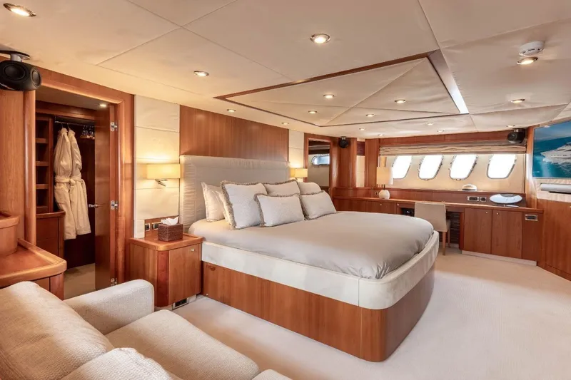 Sunseeker 90 Yacht Yacht Photos Pics Luxurious bedroom interior of 2006 Sunseeker 90 Yacht with elegant wood finishes.