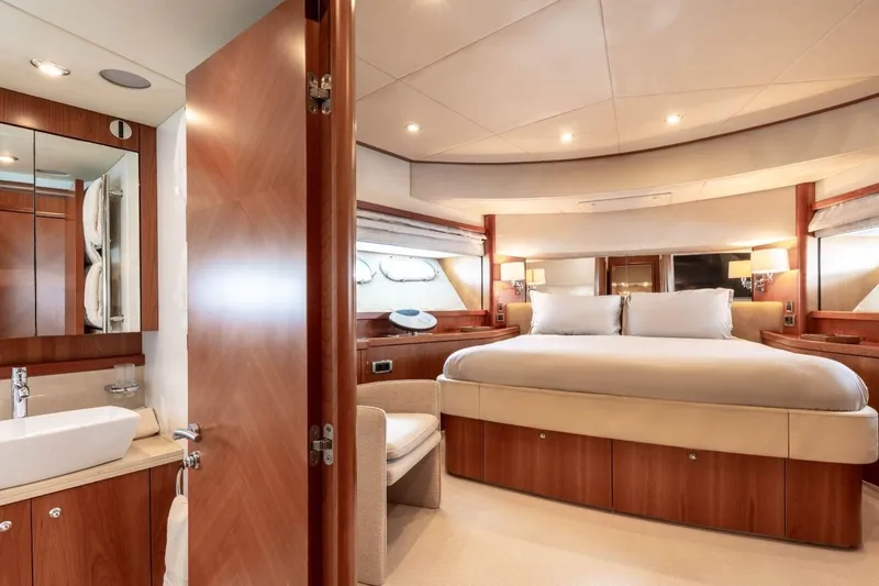 Sunseeker 90 Yacht Yacht Photos Pics Luxurious bedroom interior of 2006 Sunseeker 90 Yacht with elegant wood finishes.