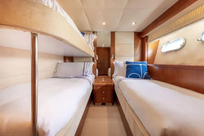 Sunseeker 90 Yacht Yacht Photos Pics Luxurious cabin interior of 2006 Sunseeker 90 Yacht with twin beds and elegant decor.