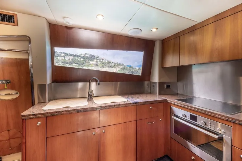 Sunseeker 90 Yacht Yacht Photos Pics Luxurious kitchen interior of 2006 Sunseeker 90 Yacht with modern appliances and wood cabinetry.