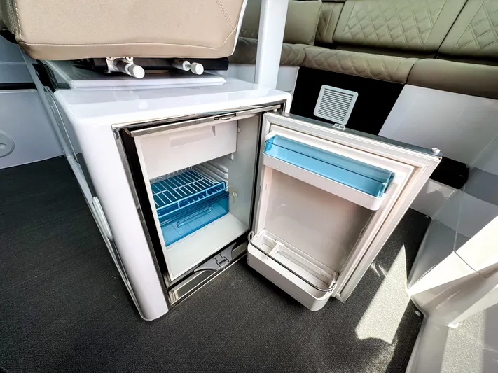  Yacht Photos Pics Open mini fridge inside 2023 Axopar 37 XC CROSS CABIN boat interior.
