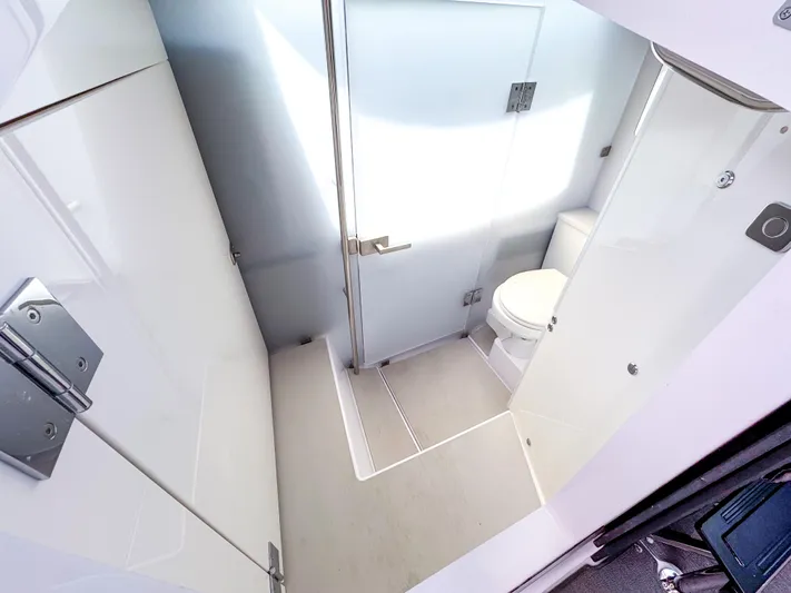  Yacht Photos Pics Modern bathroom in 2023 Axopar 37 XC CROSS CABIN boat, featuring sleek design and compact layout.