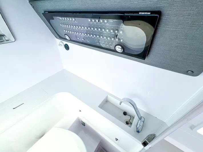  Yacht Photos Pics 2023 Axopar 37 XC CROSS CABIN interior with control panel and sink.