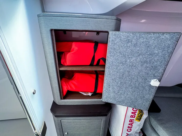 Yacht Photos Pics Storage cabinet with red life jackets inside Axopar 37 XC CROSS CABIN, 2023 model.