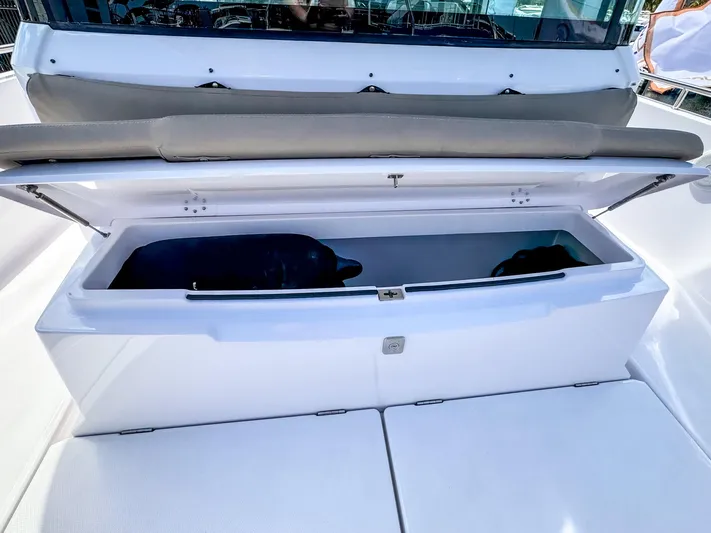  Yacht Photos Pics 2023 Axopar 37 XC CROSS CABIN storage compartment with open lid, showcasing spacious interior.