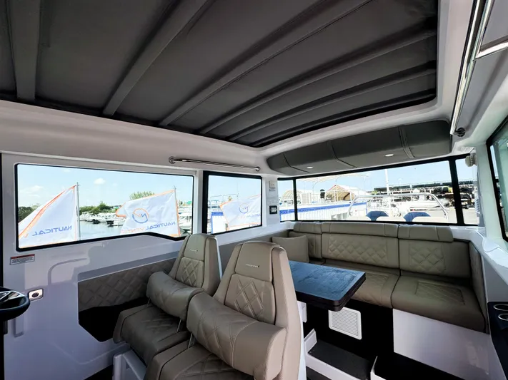  Yacht Photos Pics Interior of 2023 Axopar 37 XC CROSS CABIN with luxurious seating and panoramic windows.