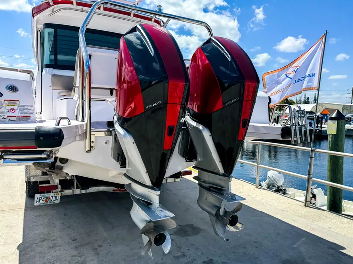  Yacht Photos Pics 2023 Axopar 37 XC CROSS CABIN with dual outboard engines at a marina dock.