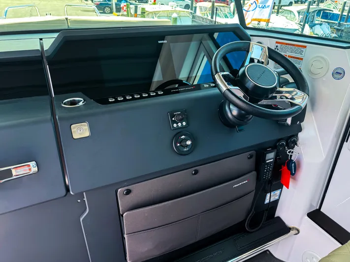  Yacht Photos Pics 2023 Axopar 37 XC CROSS CABIN helm with steering wheel and control panel.