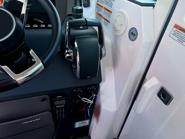  Yacht Photos Pics 2023 Axopar 37 XC CROSS CABIN helm with controls and steering wheel detail.