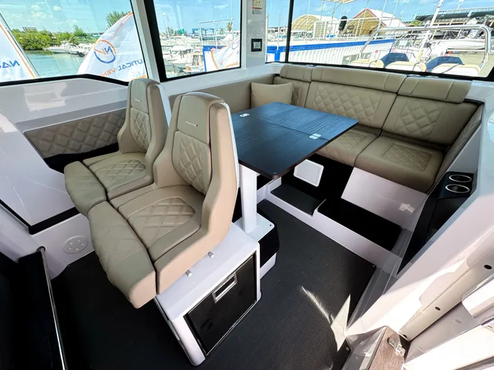  Yacht Photos Pics Interior of 2023 Axopar 37 XC CROSS CABIN with beige seating and table.