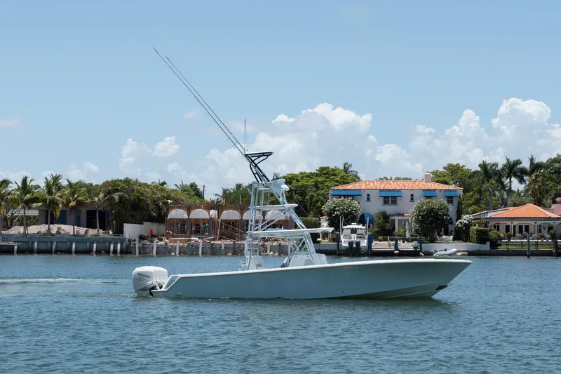  Yacht Photos Pics 2017 SeaVee Z39 boat cruising near waterfront homes under a clear blue sky.