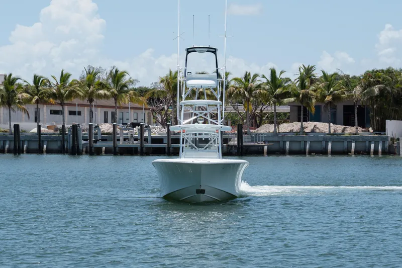  Yacht Photos Pics 2017 SeaVee Z39 boat cruising near a tropical dock with palm trees.