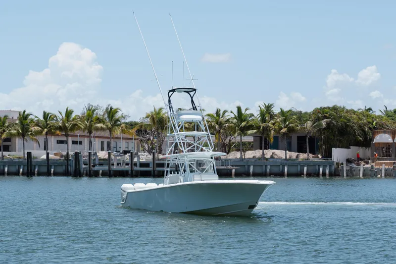  Yacht Photos Pics 2017 SeaVee Z39 boat cruising on a sunny day near palm-lined waterfront.