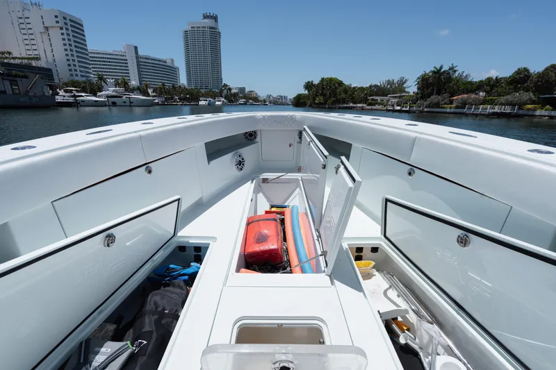  Yacht Photos Pics 2017 SeaVee Z39 boat interior with open storage compartments, docked near city buildings.