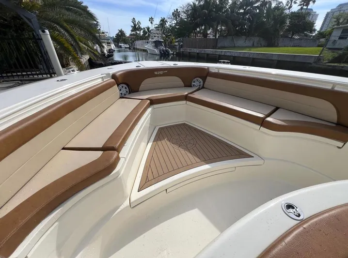 Zooropa Yacht Photos Pics 2016 Scout 420 LXF boat interior with brown seating and wood flooring.
