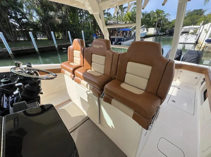 Zooropa Yacht Photos Pics Interior of 2016 Scout 420 LXF boat with luxurious seating and steering wheel.