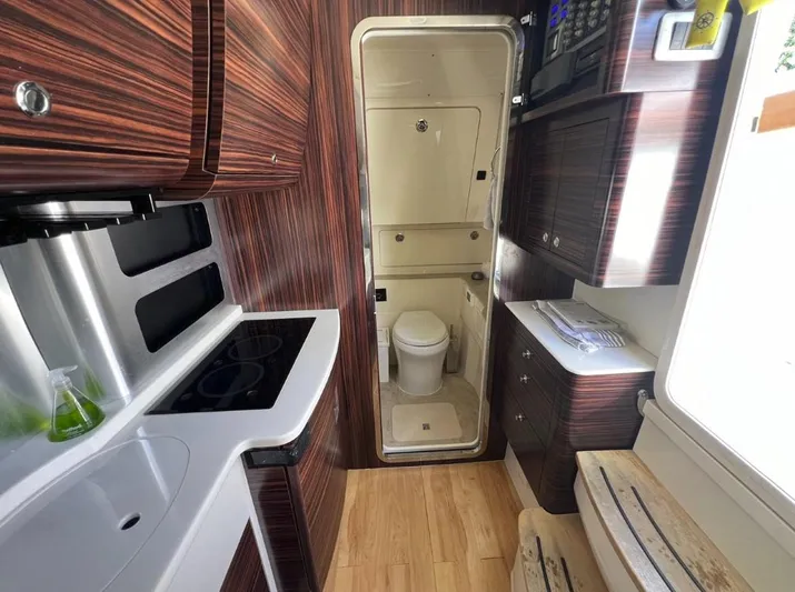 Zooropa Yacht Photos Pics Luxurious interior of 2016 Scout 420 LXF boat featuring kitchen and bathroom amenities.