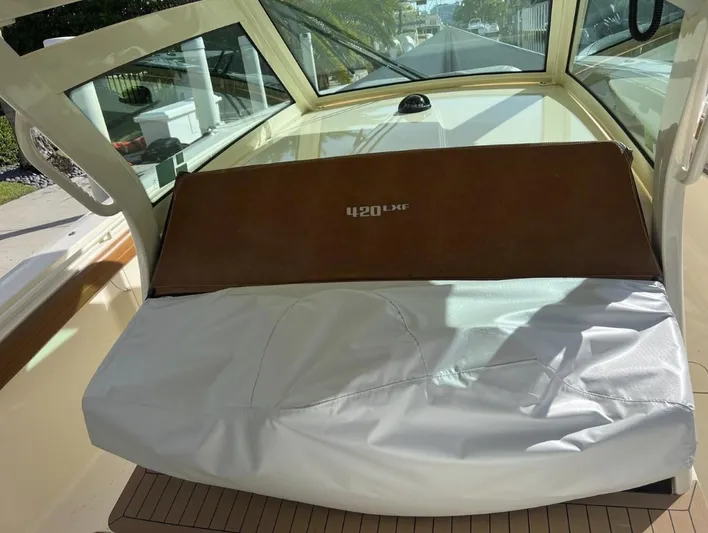Zooropa Yacht Photos Pics 2016 Scout 420 LXF boat interior with protective cover and windshield view.