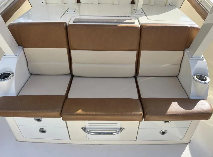 Zooropa Yacht Photos Pics 2016 Scout 420 LXF boat seating with brown and cream cushions, cup holders, and storage drawers.