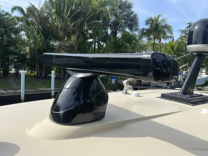 Zooropa Yacht Photos Pics Radar equipment on 2016 Scout 420 LXF boat, surrounded by lush greenery.