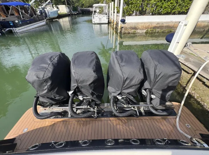 Zooropa Yacht Photos Pics Four covered outboard engines on a 2016 Scout 420 LXF boat at a dock.