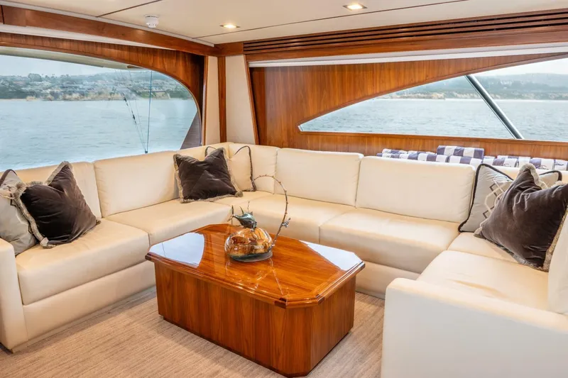 Silvertime Yacht Photos Pics Luxurious interior of 2018 Viking 80 Enclosed Bridge yacht with elegant seating and ocean view.