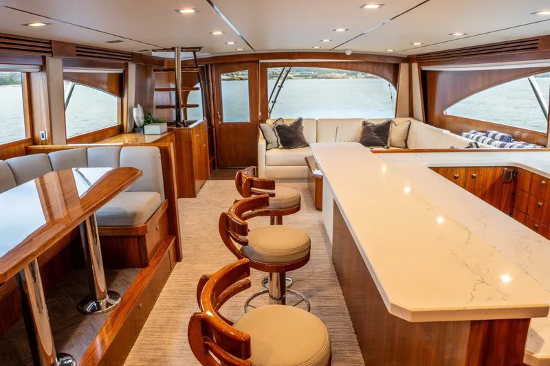 Silvertime Yacht Photos Pics Luxurious interior of 2018 Viking 80 Enclosed Bridge yacht with elegant seating and dining area.