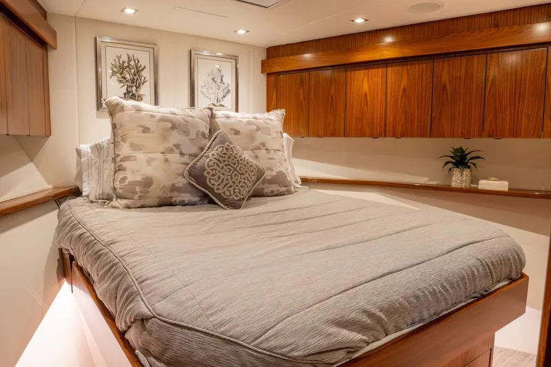 Silvertime Yacht Photos Pics Luxurious bedroom interior on 2018 Viking 80 Enclosed Bridge yacht with elegant wood finishes.