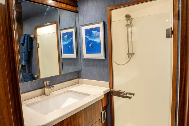 Silvertime Yacht Photos Pics Luxurious bathroom in 2018 Viking 80 Enclosed Bridge yacht with modern shower and elegant decor.