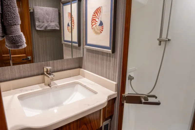 Silvertime Yacht Photos Pics Luxurious bathroom in 2018 Viking 80 Enclosed Bridge yacht with modern fixtures.