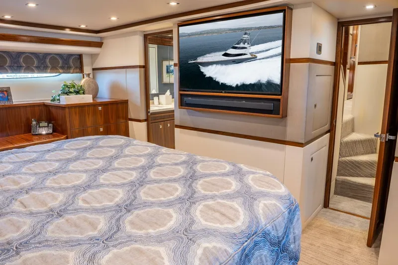 Silvertime Yacht Photos Pics Luxurious bedroom interior of 2018 Viking 80 Enclosed Bridge yacht with TV and elegant decor.