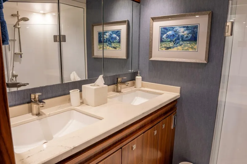 Silvertime Yacht Photos Pics Luxurious bathroom in 2018 Viking 80 Enclosed Bridge yacht with dual sinks and elegant decor.