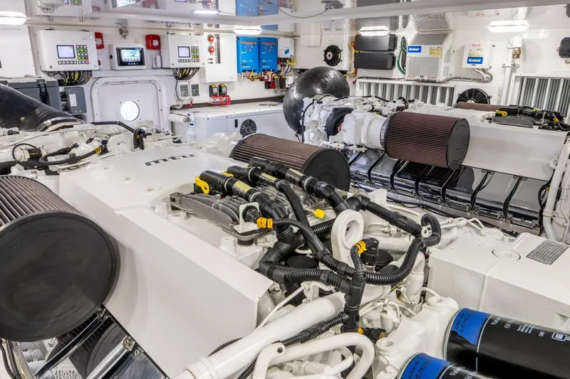 Silvertime Yacht Photos Pics Engine room of 2018 Viking 80 Enclosed Bridge yacht, showcasing advanced machinery and controls.