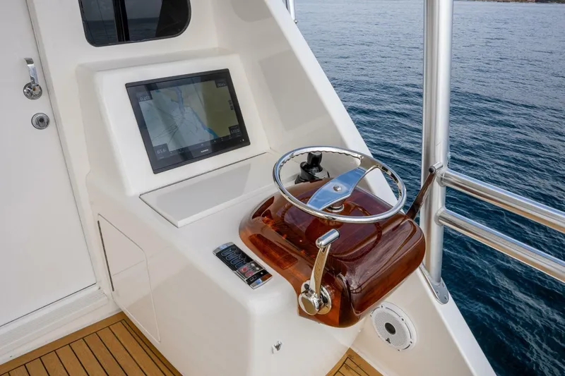 Silvertime Yacht Photos Pics Steering console of 2018 Viking 80 Enclosed Bridge yacht with navigation display.