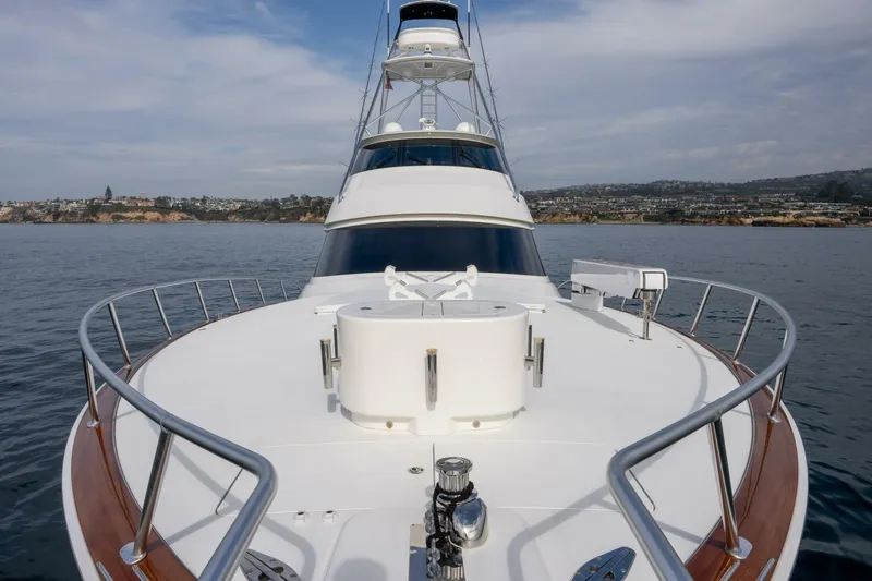 Silvertime Yacht Photos Pics 2018 Viking 80 Enclosed Bridge yacht on calm waters with coastal background.