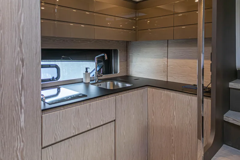  Yacht Photos Pics Modern kitchen interior of 2020 Azimut Atlantis 45 yacht with sleek cabinetry and fixtures.