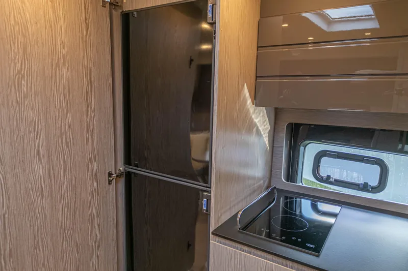  Yacht Photos Pics Modern kitchen interior of 2020 Azimut Atlantis 45 yacht with sleek cabinetry and stove.