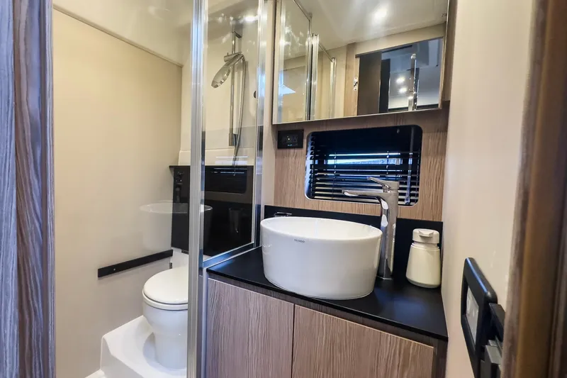  Yacht Photos Pics Luxurious bathroom in 2020 Azimut Atlantis 45 yacht with modern fixtures and elegant design.
