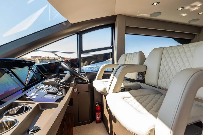  Yacht Photos Pics Luxurious interior of 2020 Sunseeker Manhattan 52 yacht with modern helm and seating.