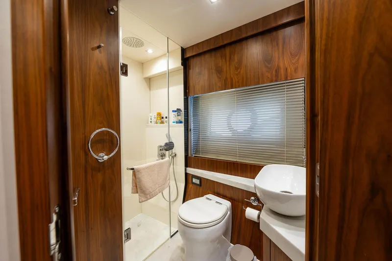  Yacht Photos Pics Luxurious bathroom in 2020 Sunseeker Manhattan 52 yacht with wood accents and modern fixtures.