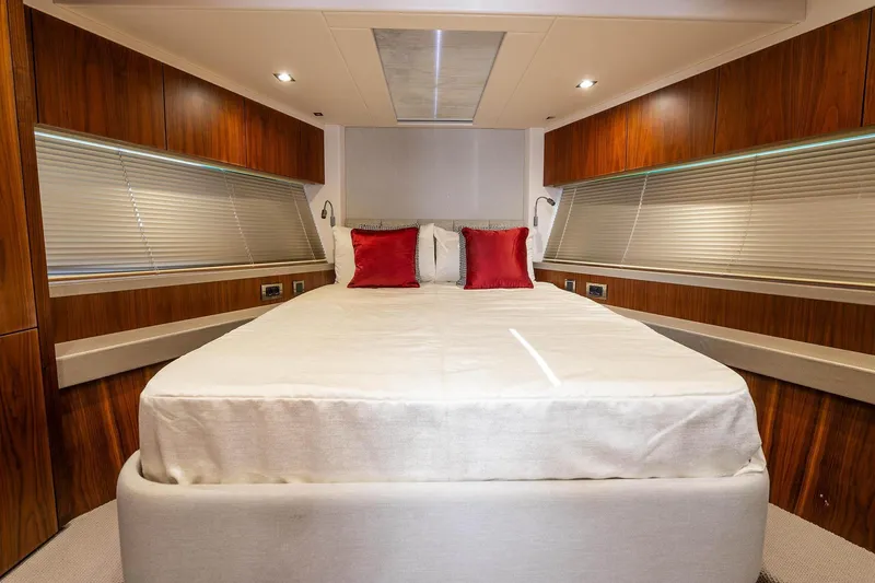  Yacht Photos Pics Luxurious bedroom interior of 2020 Sunseeker Manhattan 52 yacht with elegant wood paneling.