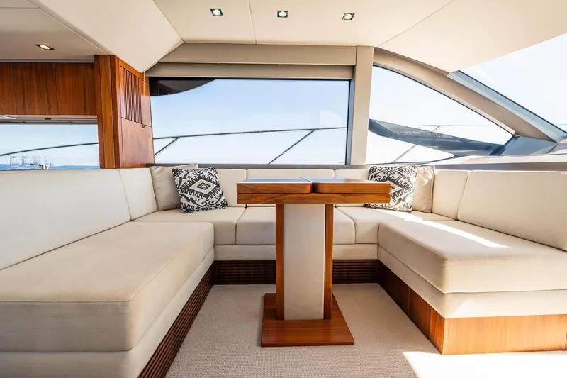  Yacht Photos Pics Luxurious interior of 2020 Sunseeker Manhattan 52 yacht with elegant seating and wooden accents.