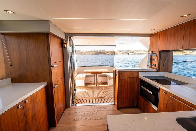  Yacht Photos Pics Luxurious interior of 2020 Sunseeker Manhattan 52 yacht with modern kitchen and ocean view.