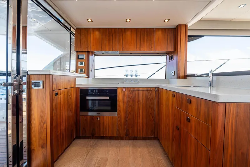  Yacht Photos Pics Luxurious kitchen interior of 2020 Sunseeker Manhattan 52 yacht with wooden cabinetry.