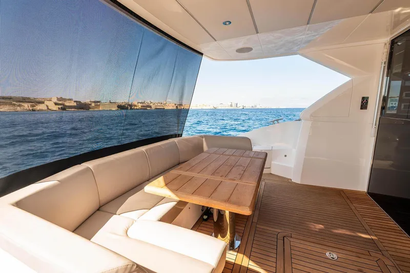  Yacht Photos Pics Luxurious Sunseeker Manhattan 52 yacht deck with seating and ocean view, 2020 model.