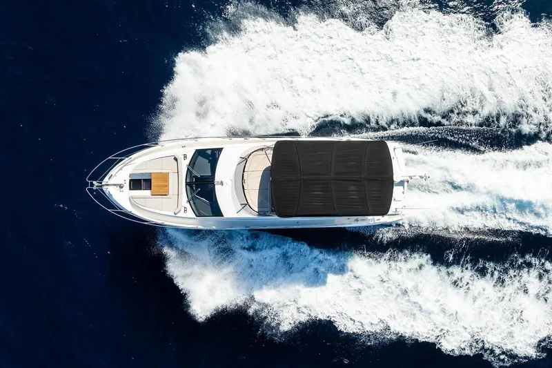  Yacht Photos Pics Aerial view of 2020 Sunseeker Manhattan 52 yacht cruising on open water.