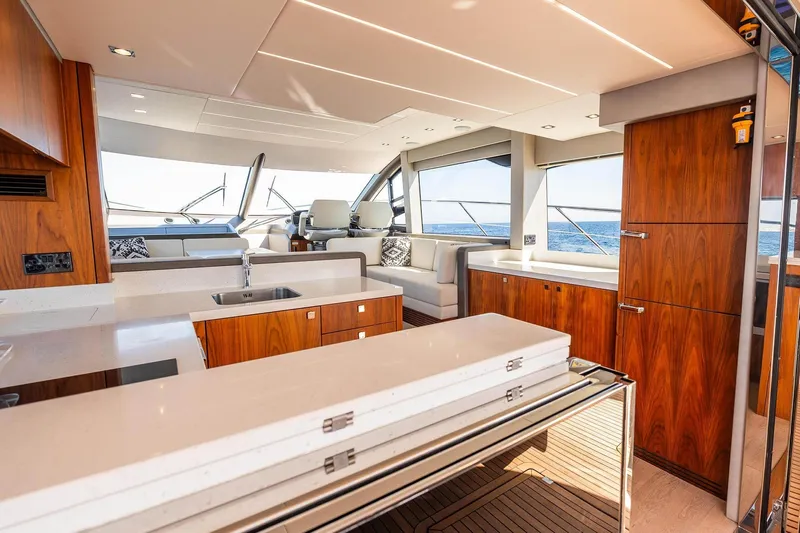  Yacht Photos Pics Luxurious interior of 2020 Sunseeker Manhattan 52 yacht with modern wood finishes and ocean view.