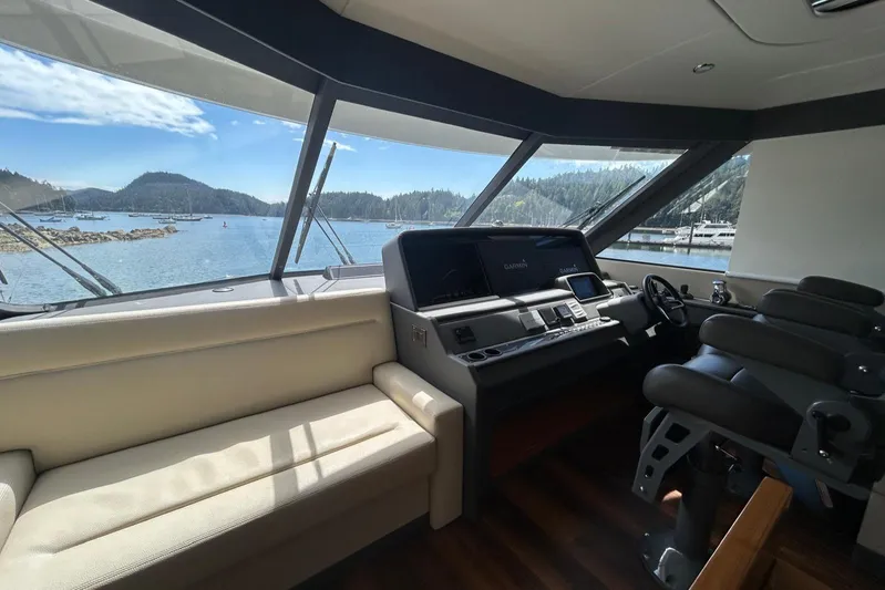  Yacht Photos Pics Interior view of 2020 Maritimo M64 yacht helm with scenic ocean backdrop.